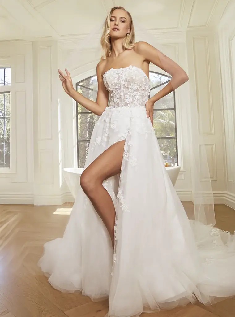 Model wearing a white gown by Casablanca Bridal