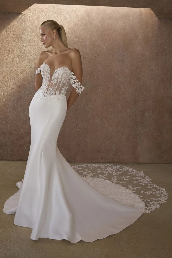 Model wearing a white gown by Casablanca Bridal